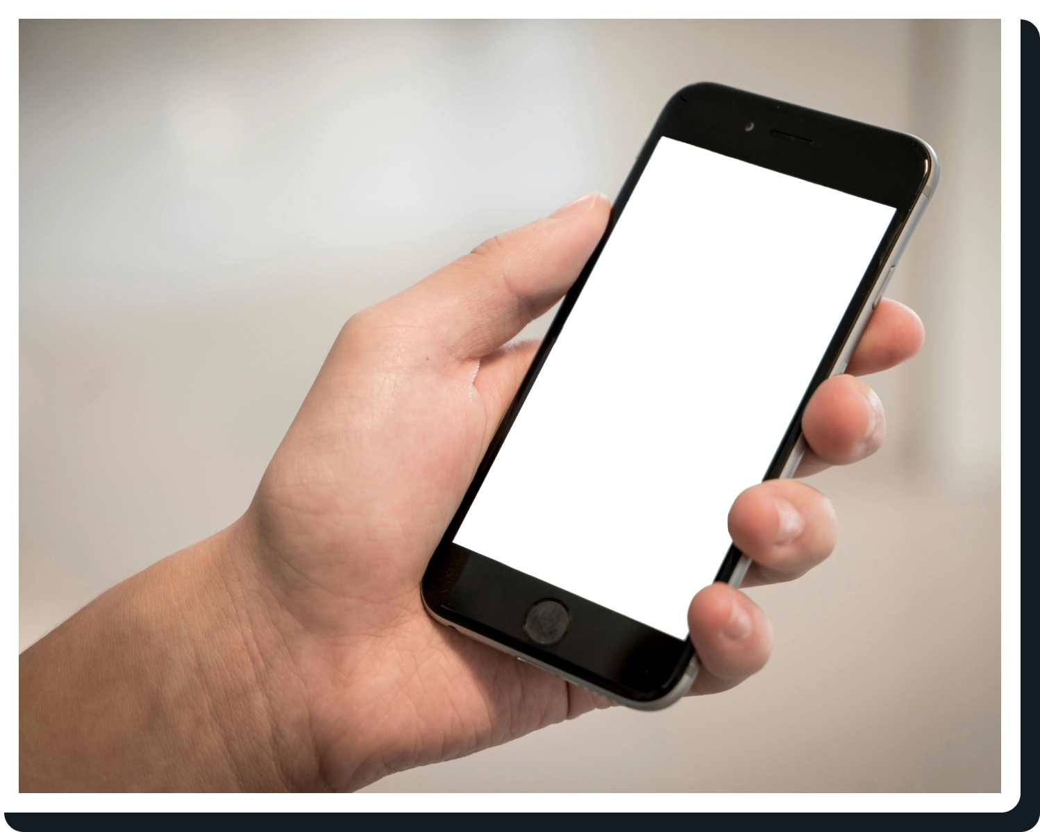 A person holding an iphone with white screen.