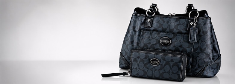 Black Coach signature tote handbag with matching wallet displayed on a clean light gray background with open space for promotional text.